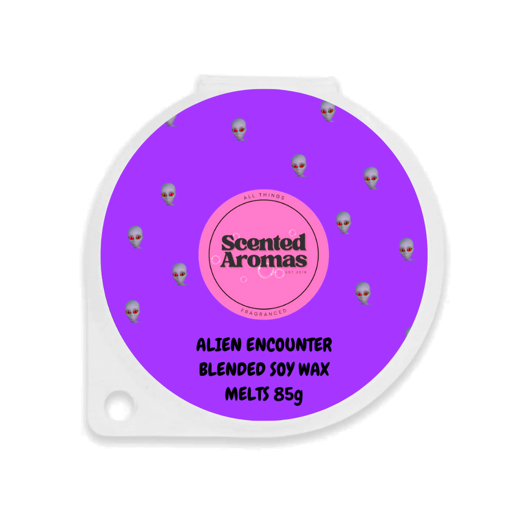 The Soap Gals offer the Alien Luxury Wax Melts in an 85g round container with a purple design featuring small alien faces. Labeled "Scented Aromas" and "Alien Encounter," these soy wax melts provide one of the strongest smelling luxury experiences in the UK.