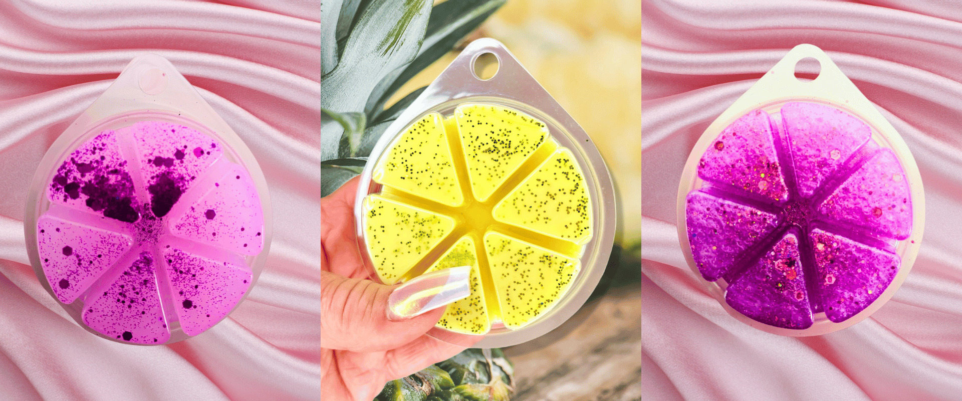 Three circular, segmented wax melts in pink, yellow, and purple hues are displayed on a pink satin fabric, with a hand holding the yellow one in the center.
