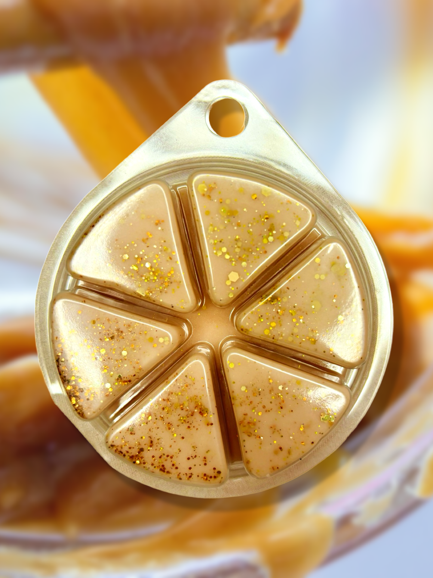 Close-up of The Soap Gal x's Salted Caramel Popcorn Wax Melt 85g, crafted in the UK and designed in a honeycomb shape with six segments, adorned with gold glitter, and releasing a captivating scent of sweet salted caramel popcorn.