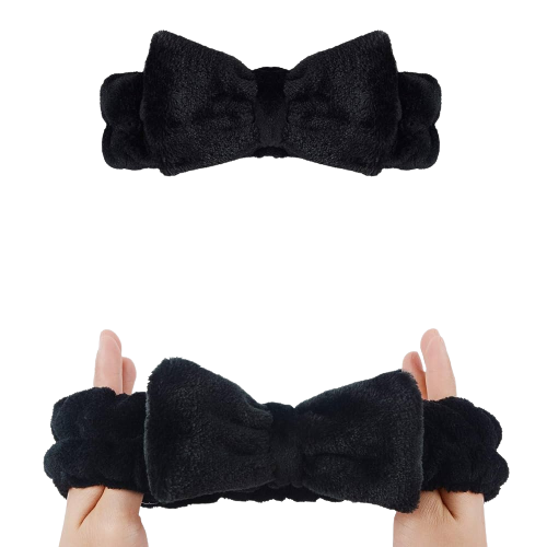 Two hands holding The Soap Gal x Black Big Fluffy Headband against a black background.