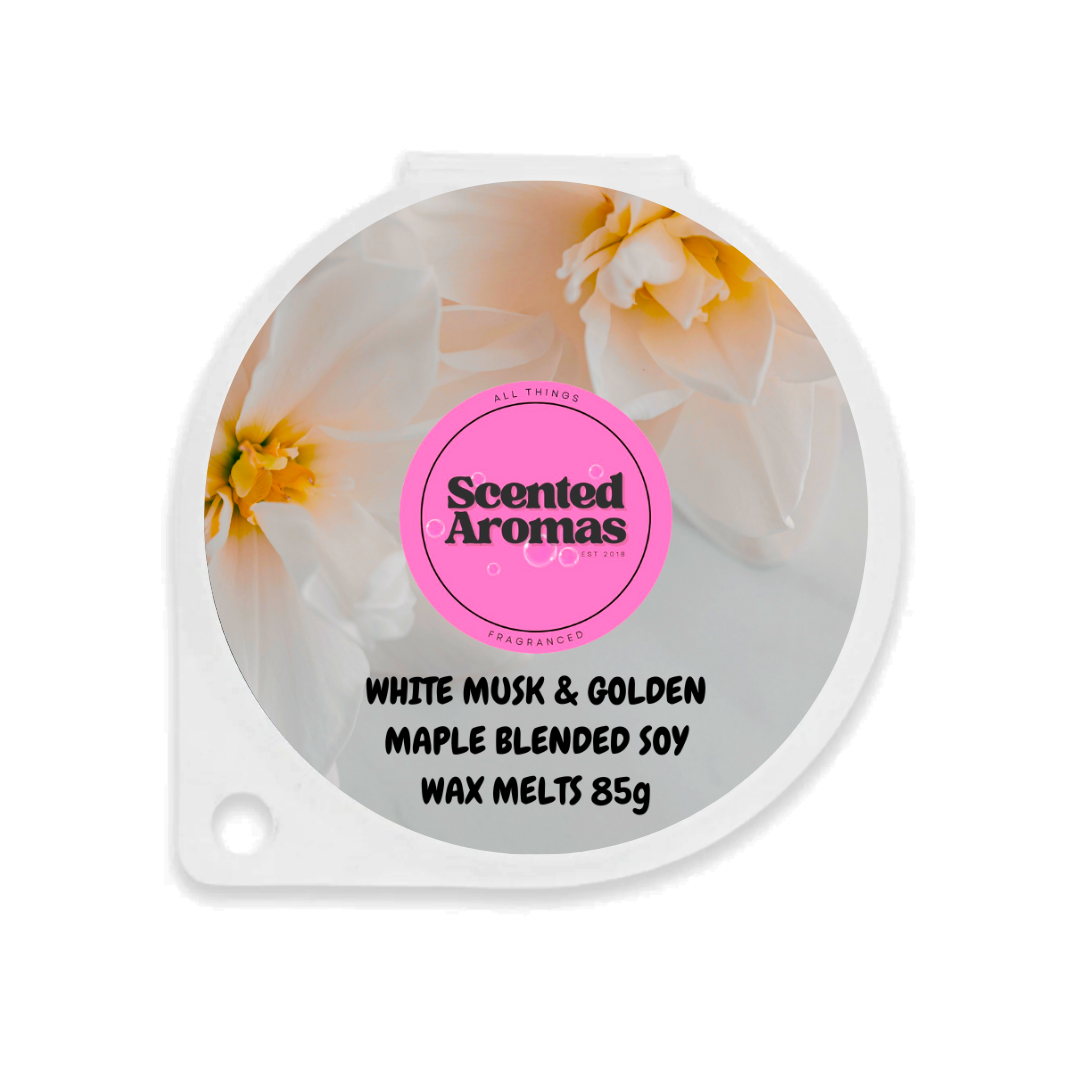 A round container of wax melts with a lid featuring white and yellow flowers reads elegantly: "The Soap Gal x Hinch's White Musk and Golden Maple Wax Melts 85g," capturing the essence reminiscent of Mrs Hinch laundry scents.